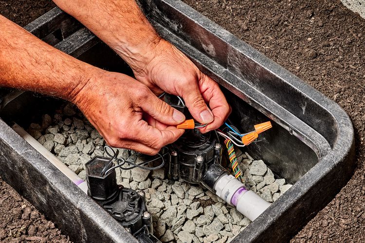 Technician replacing a sprinkler valve in Sterling Heights